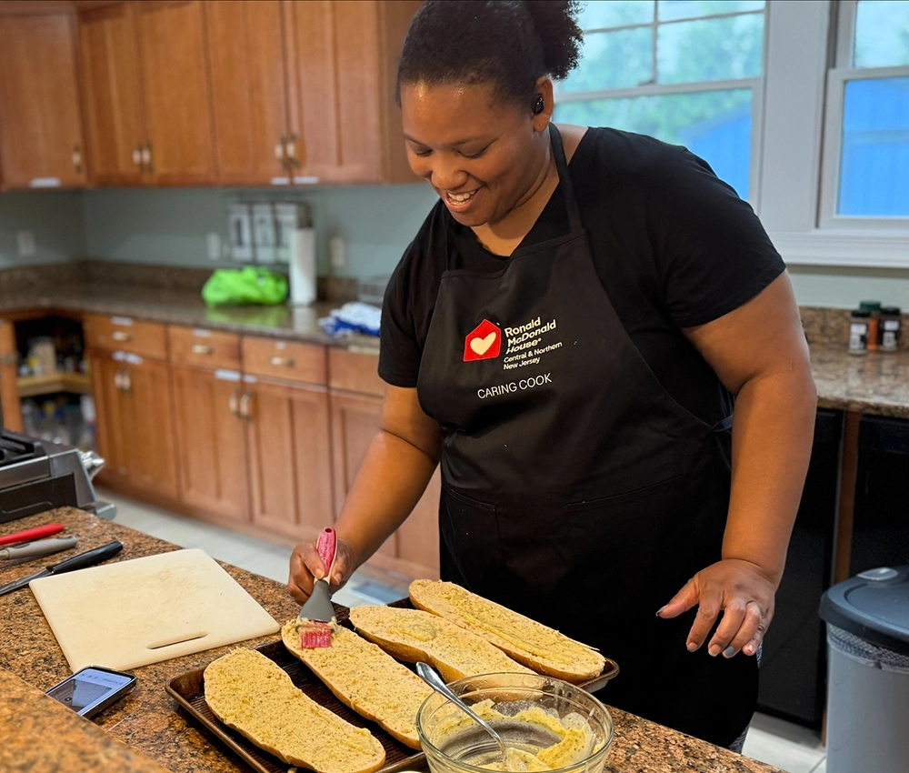a caring cook volunteer preparing garlic bread