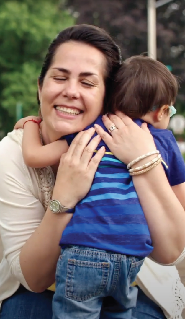 Mom hugging son outdoors